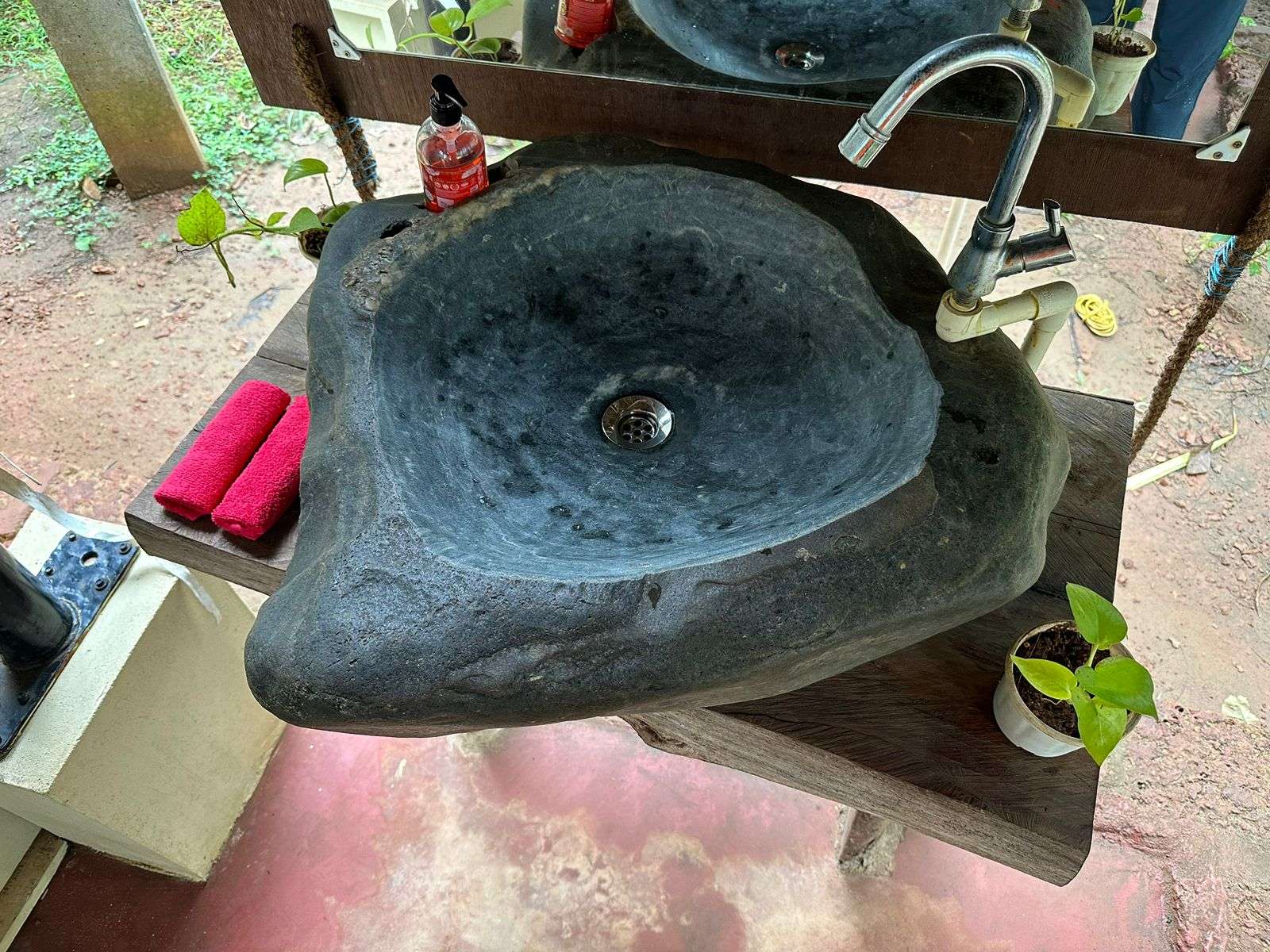Boutique Casa - A beautifully crafted washbasin surrounded by natural elements, creating a refreshing and tranquil atmosphere.