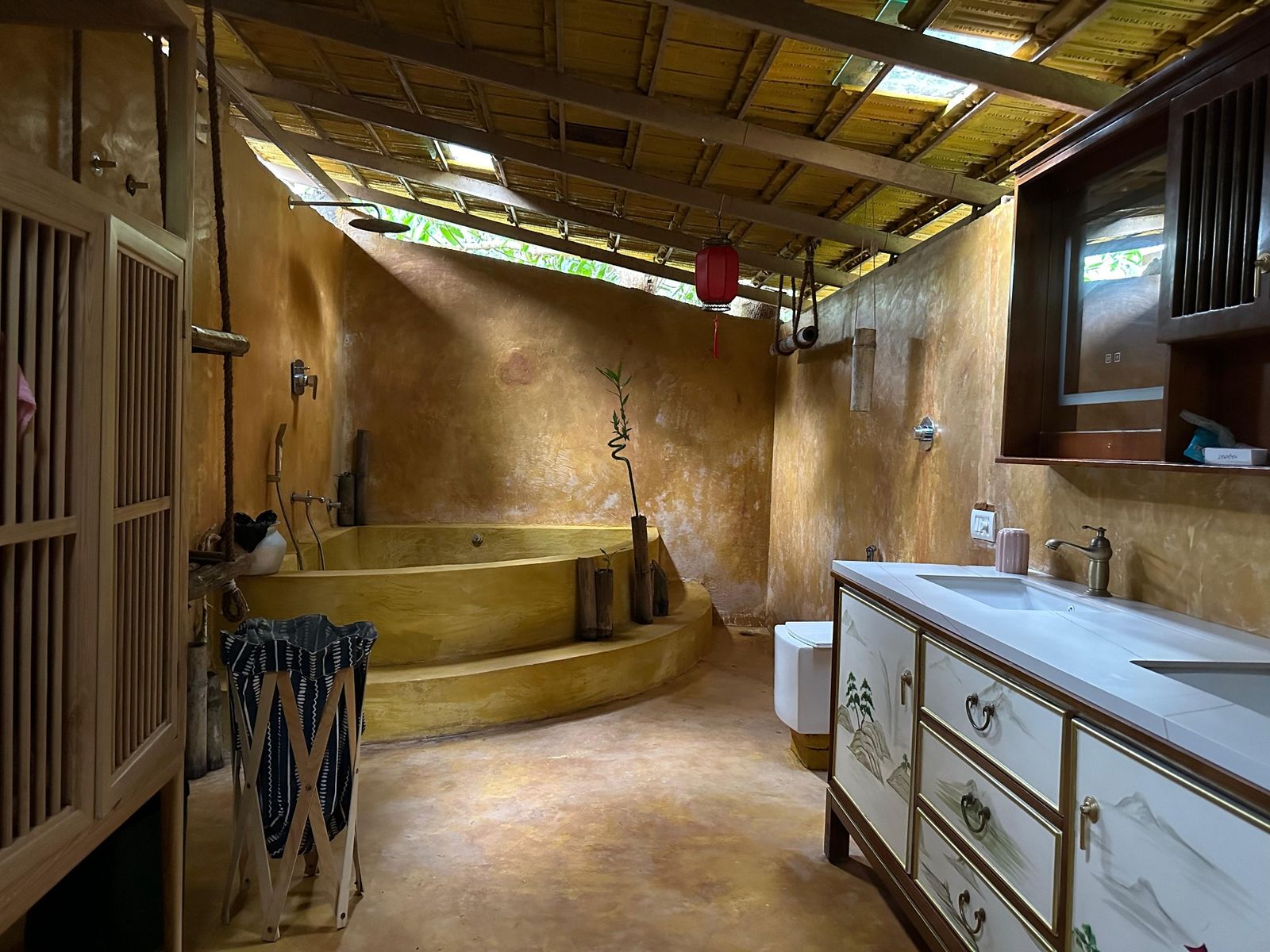 Oriental Royal Cottage - Indulge in a spacious, elegant bathroom featuring a luxurious bathtub for a relaxing, spa-like experience.